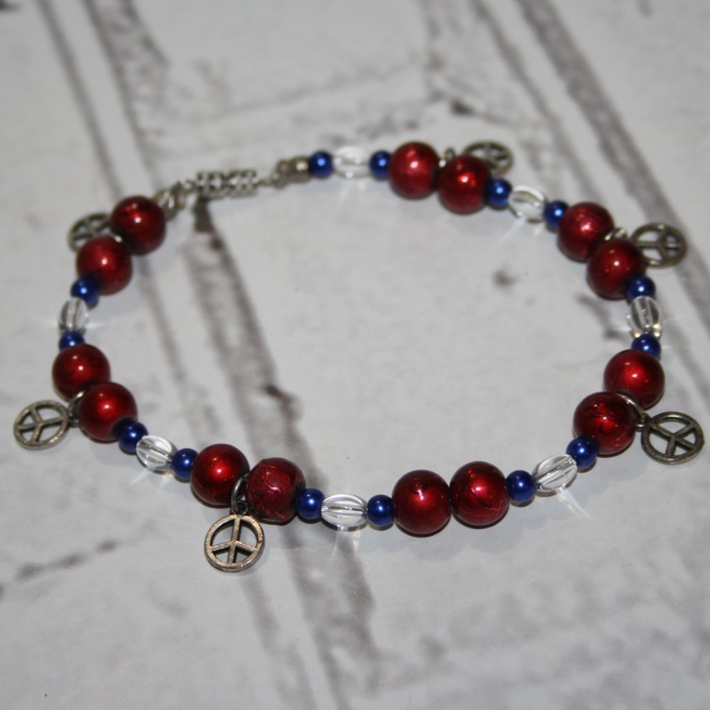 Beautiful red and blue glass beaded ankle bracelet with silver peace sign